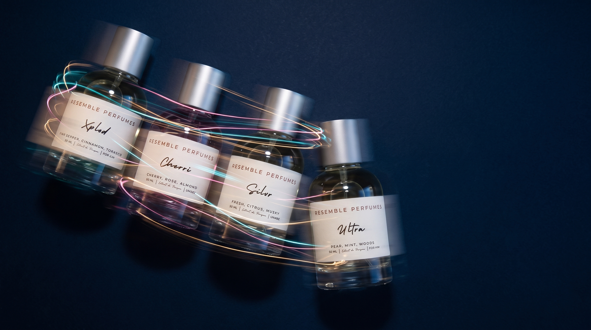Four Resemble Perfumes extrait de parfum bottles on deep navy with streaks of coloured light