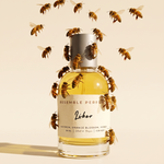 Liber extrait de parfum by Resemble Perfumes surrounded by honeybees on a warm honey background