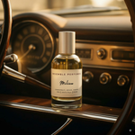 Milion extrait de parfum by Resemble Perfumes on the dashboard of a classic car